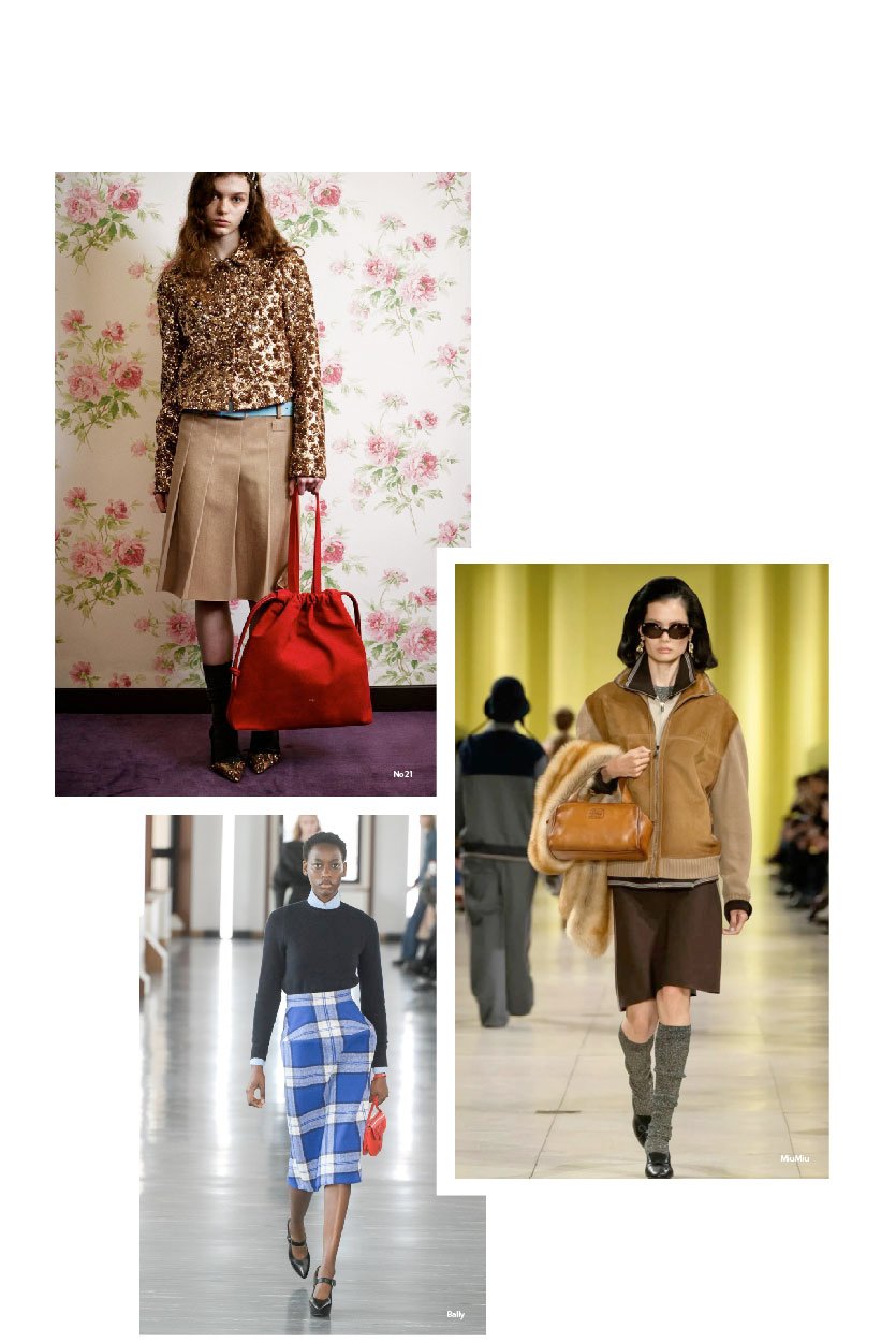 A model walks the runway in a reinterpreted preppy look featuring a pleated mini skirt, oversized blazer, and layered knitwear for FW25/26.